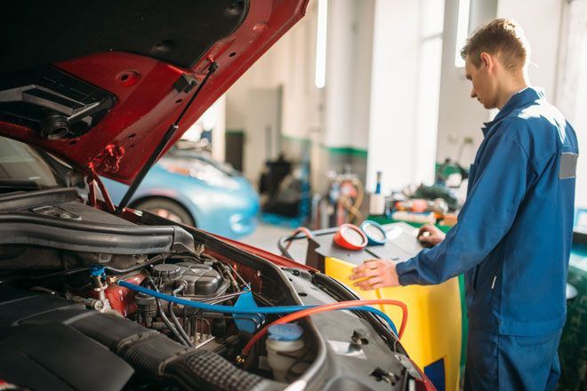 A car technician working a car